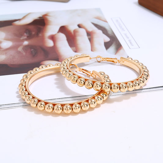 House of Royal Jasper beaded gold hoop earrings on picture background flat lay