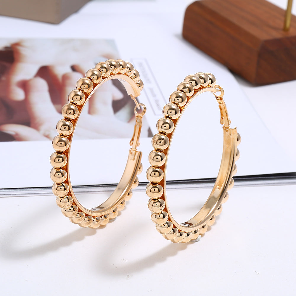 House of Royal Jasper beaded gold hoop earrings on picture background