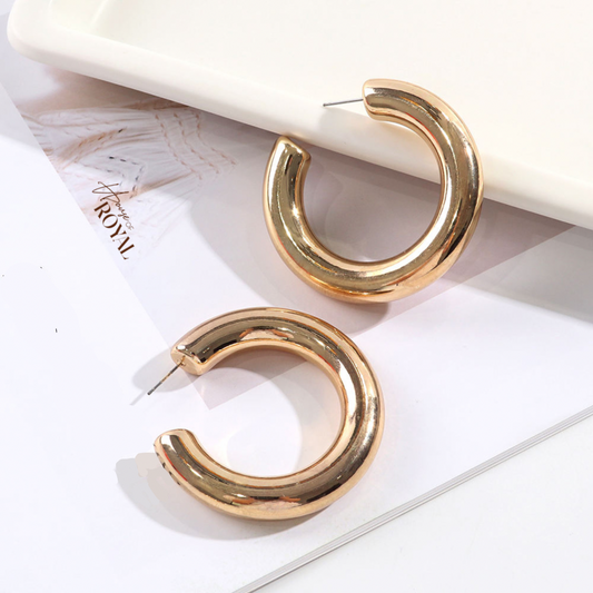 House of Royal Adira chunky gold hoop earrings on picture background