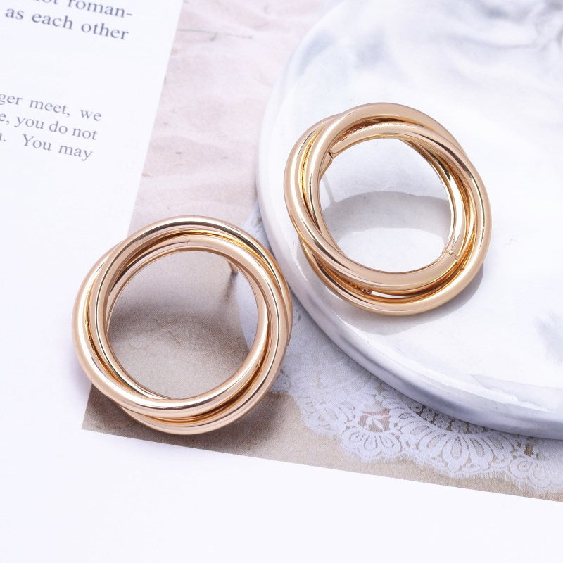 House of Royal Nara gold hoop earrings on picture background