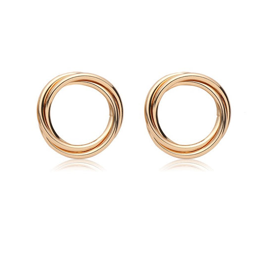 House of Royal Nara gold hoop earrings on plain background