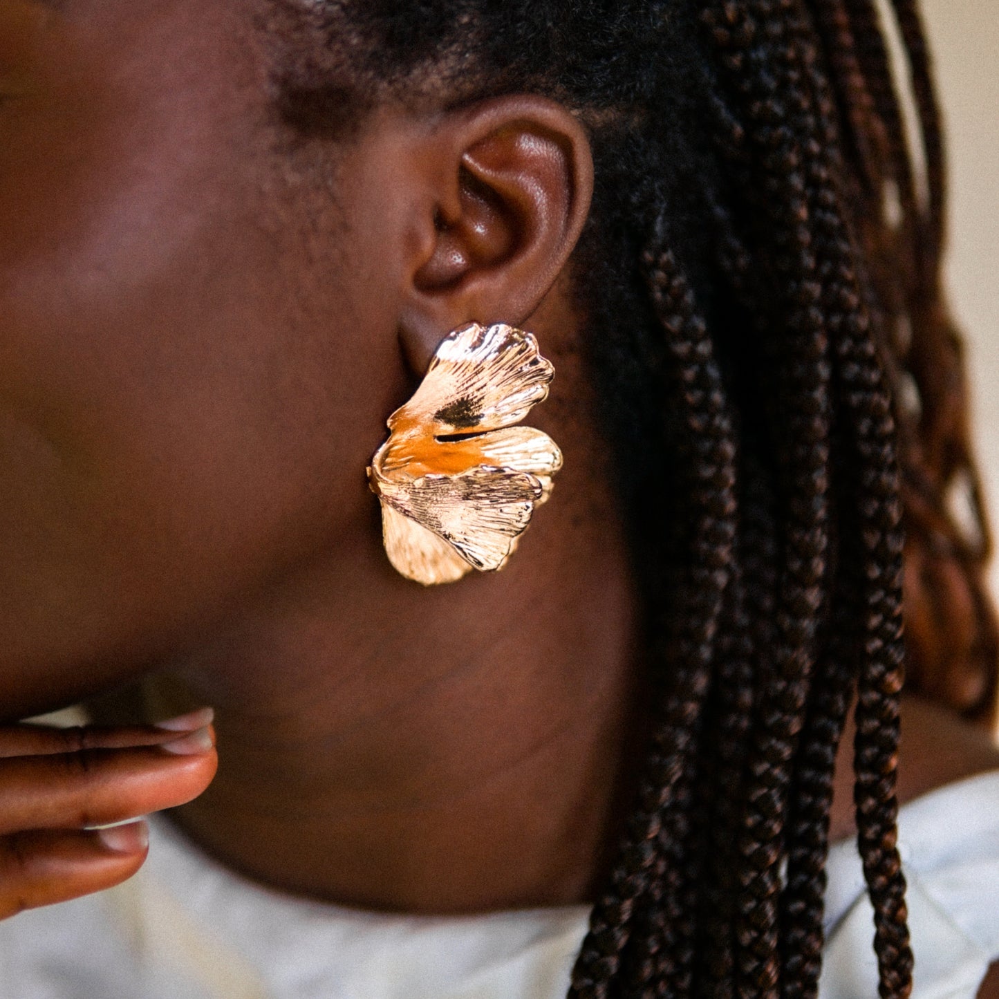 House of Royal Dena flower petal design gold earrings on model