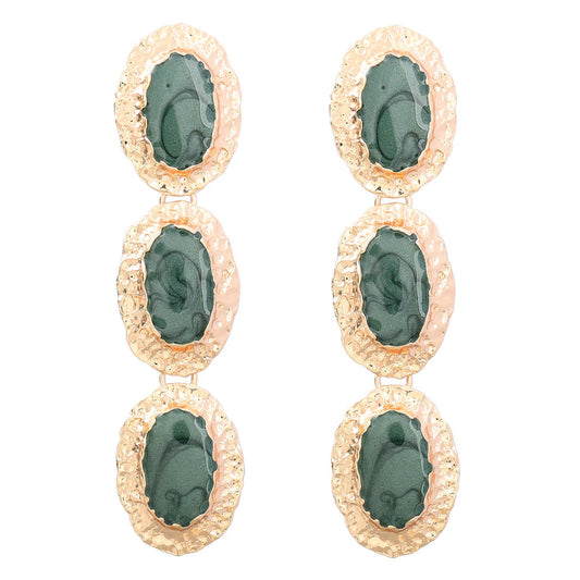 House of Royal Jaffa gold earrings with green gem stones on plain background