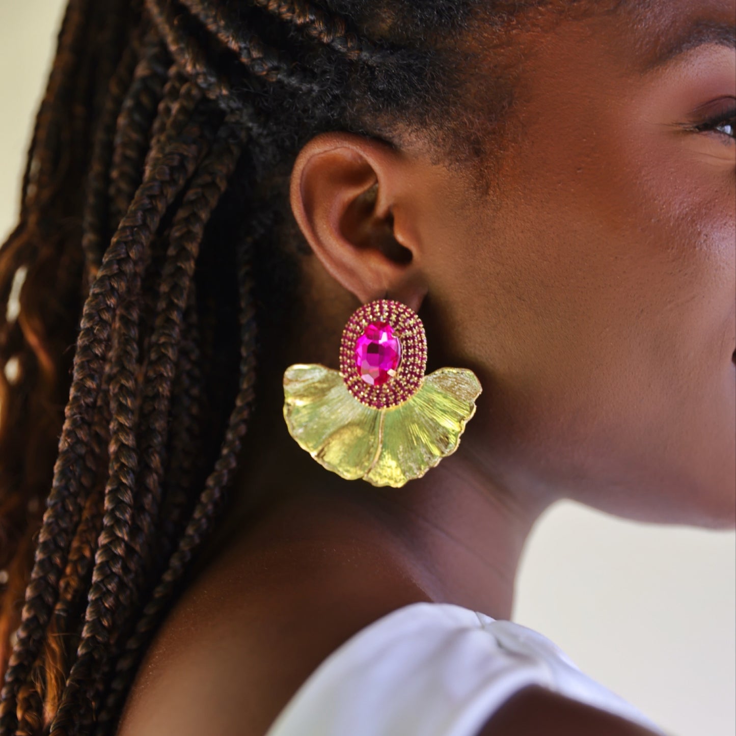 House of Royal Anais statement gold earrings with flower petal and pink gem stone design on model