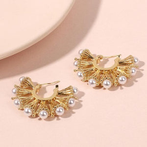 House of Royal Anelle huggie gold earrings with pearl studs product image on pink background