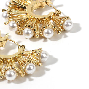 House of Royal Anelle huggie gold earrings with pearl studs product image on flat angle photo