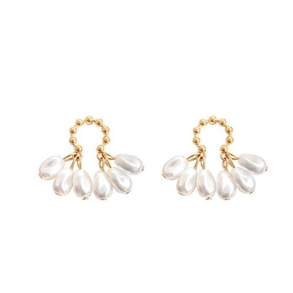 House of Royal Chloe small pearl and gold earrings on plain background